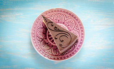 Chocolate cake on the purple plate