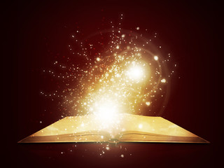 Old open book with magic light and falling stars