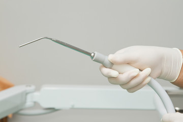 Dentist's hand  holding dental tool in dental clinic