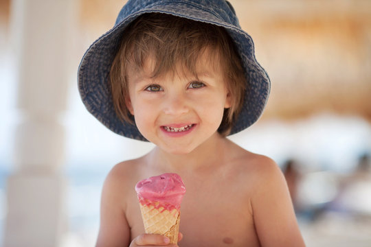 Cute Shirtless Boy, Eating Ice Cream On The Beach