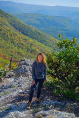 Girl tourist resting on top of a mountain in Crimea