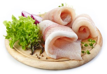 raw fish fillets on wooden cutting board