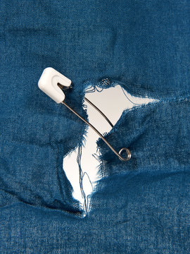 Safety Pin Holding Torn Fabric