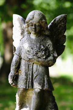 small female child winged angel Gravestone statue in cemetery