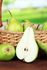 Pears in  wicker basket, on bright background