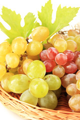 Ripe sweet grape in basket, isolated on white