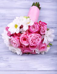 Beautiful wedding bouquet on wooden background