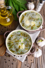 Delicious green soup with sorrel on table close-up