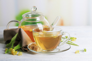 Tasty herbal tea with linden flowers on wooden table