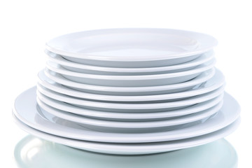 Set of white dishes on table on light background
