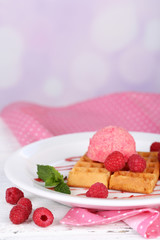 Tasty belgian waffles with ice cream on wooden table