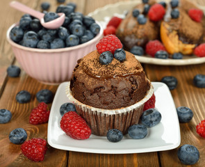 Fototapeta na wymiar Chocolate muffin with berries