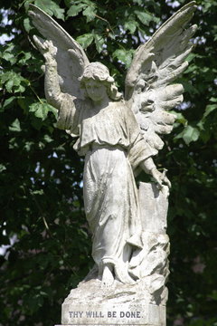 	 stone statue of woman angel with wings in cemetery	