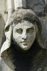 weathered statue of womans head