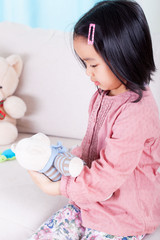 Asian girl and her teddy bear