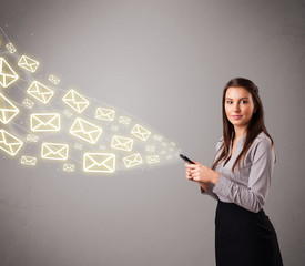 attractive young lady holding a phone with message icons