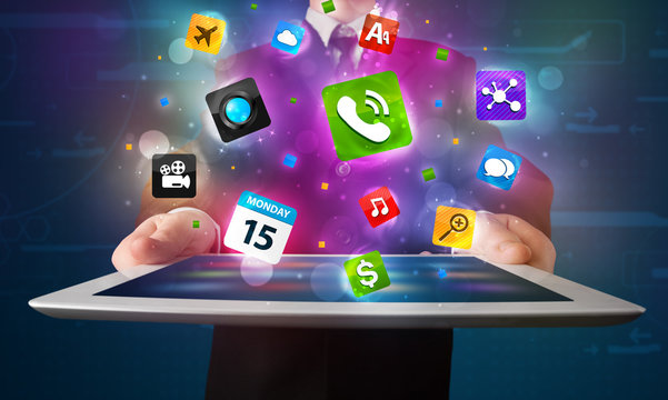 Businessman holding a tablet with modern colorful apps and icons