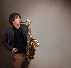 Young musician playing on saxophone
