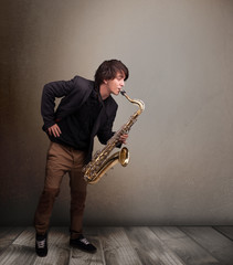 Young musician playing on saxophone