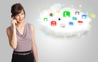 Young woman presenting cloud with colorful app icons and symbols