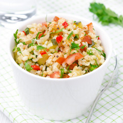 Tabbouleh salad in a white bowl, top view