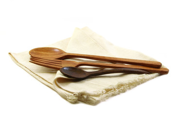 Table set, wood fork spoon and coffee spoon on napkin isolated o