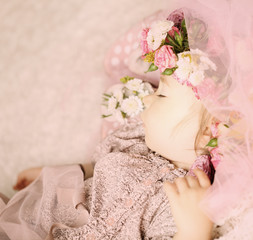 Baby girl dreaming in flowers and lace