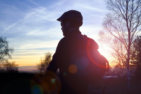 Mountain biker on a mountain track at sunset