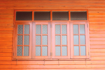 windows on brown wooden wall in house.