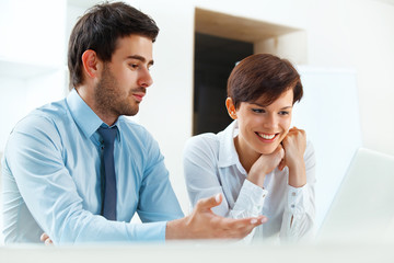 Smiling business people working together in the office