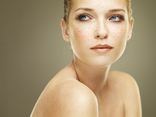 Portrait of a beautiful brunette with freckles