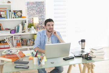 young student works on his laptop at home