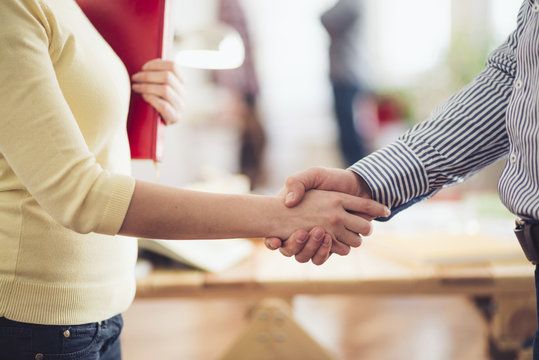 Interior designer shaking the hand of customer