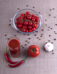 Glass of tomato juice with tomatoes, garlic and pepper
