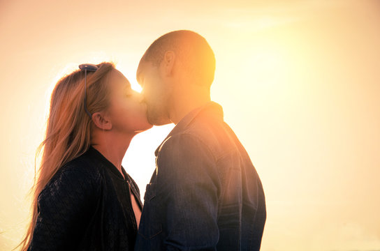Couple at sunset kissing themselves