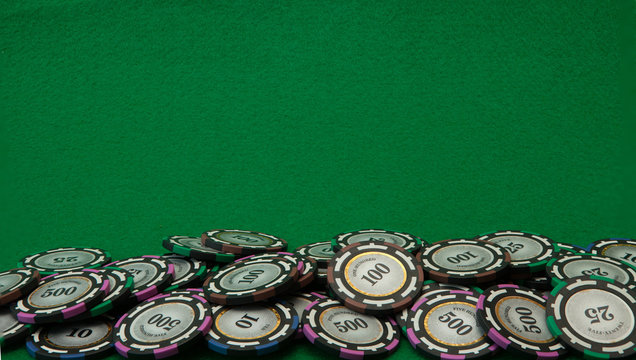 Casino chips on green background