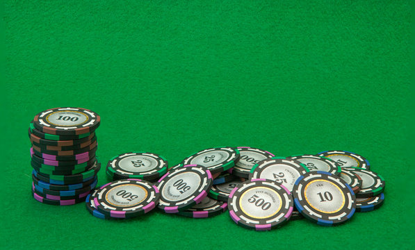 Casino chips on green background