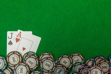 Jack and ace blackjack cards with chips on green background