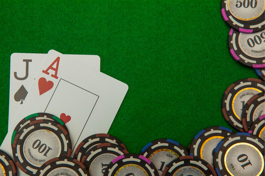 Jack and ace blackjack cards with chips on green background