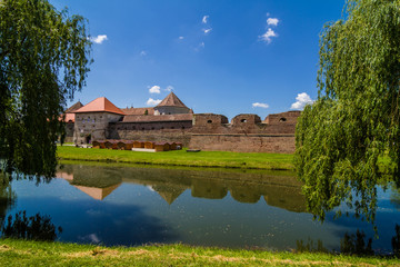 Fototapeta premium Medieval castle and it's water reflection, Fagaras, Romania