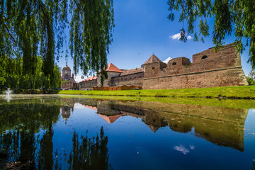 Fototapeta na wymiar Medieval castle and it's water reflection, Fagaras, Romania