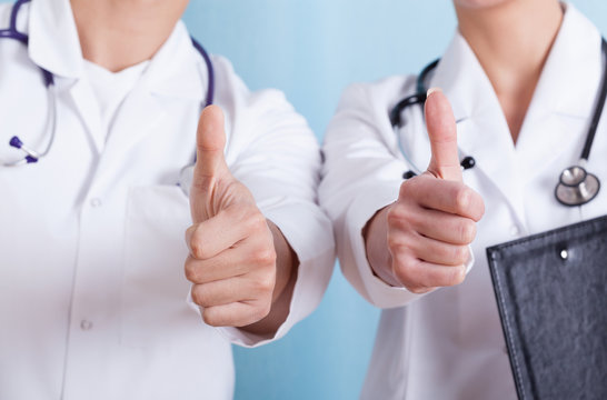 Close-up of a doctors showing thumbs up sign