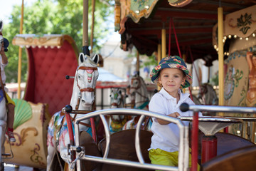 Cute kid, riding on a carousel © Tomsickova