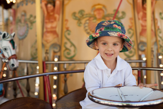 Cute kid, riding on a carousel