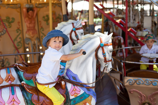 Cute kid, riding on a carousel