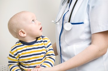 Baby looking at doctor