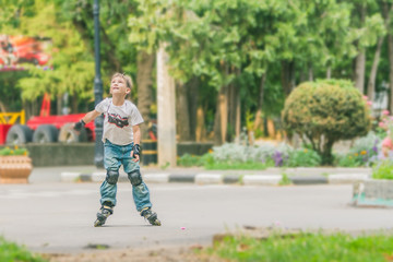Fototapeta premium young happy boy faving fun on roller scates on natural backgroun