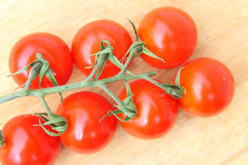 Cherry tomatoes on wooden table close up