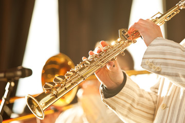 Hands of musician playing the soprano saxophone