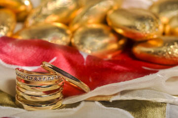  wedding rings on colorful fabric